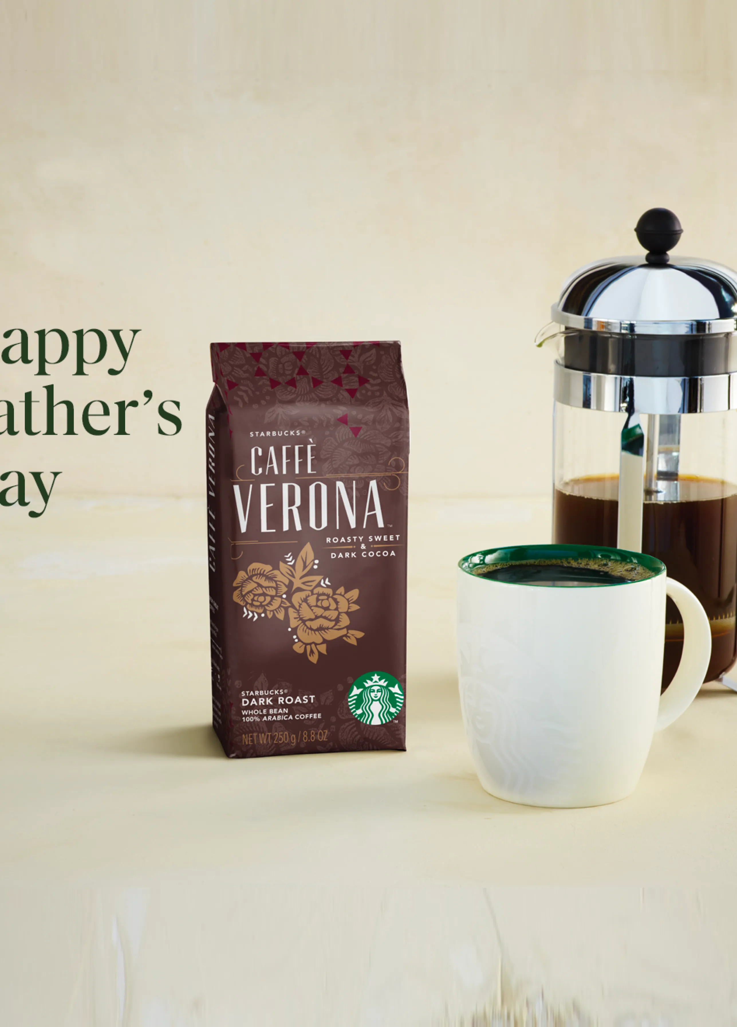 A bag of Starbucks Whole Bean Coffee, french press and mug sit atop a marble counter surface.