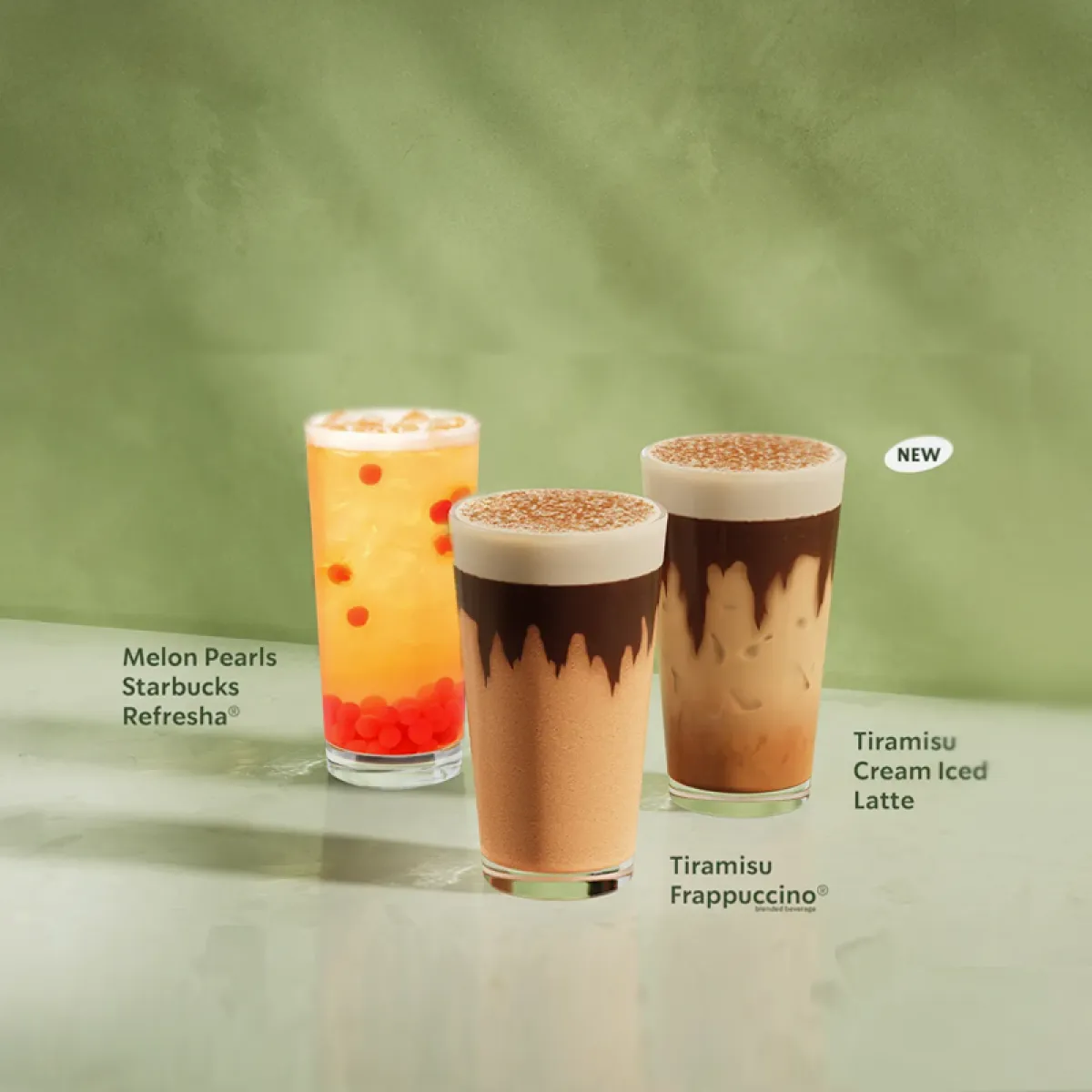 The starbucks summer range sits alot a table against a marbled green background.