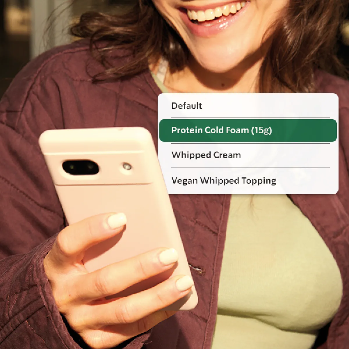 A customer uses her phone to order, with an overlay showing her selecting Protein Cold Foam