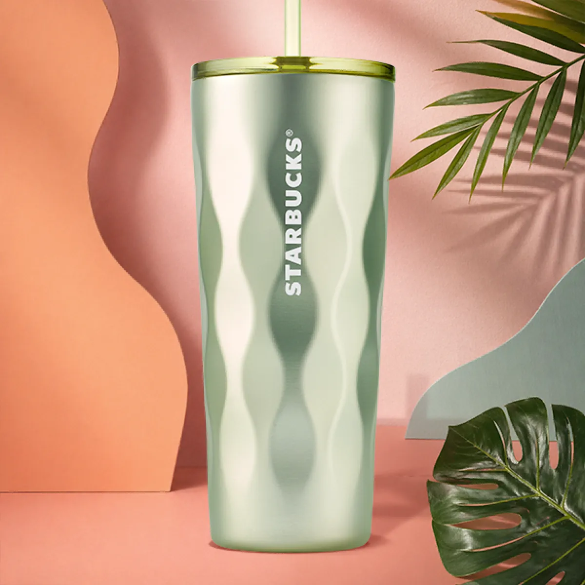 A photo of our new 24oz stainless steel, sage green ripple textured cold cup, with plastic green screw lid and straw.