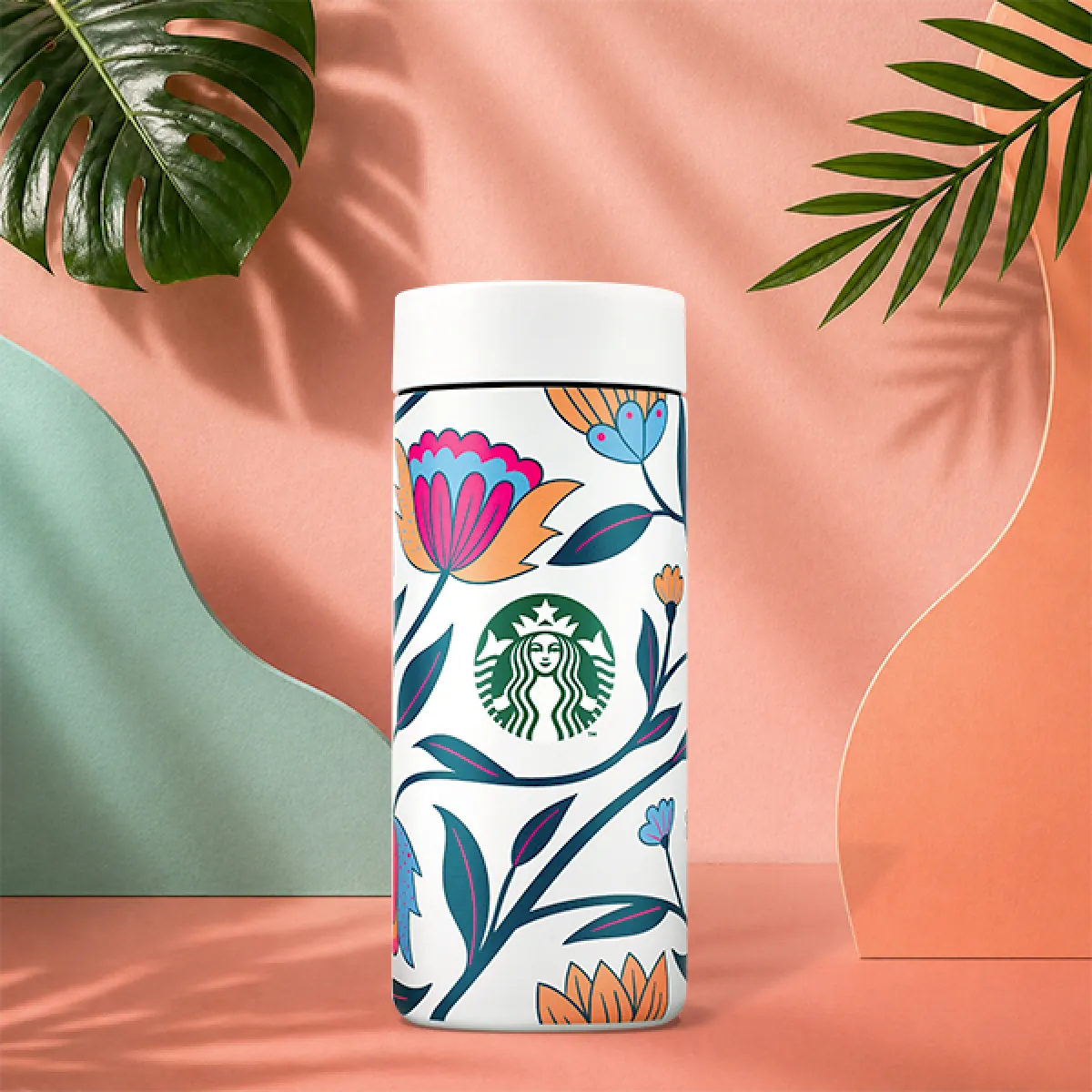 A photo of our new summer tumbler, a brightly coloured, bold, vintage floral design on an ivory background, with a pop mechanic lid. 