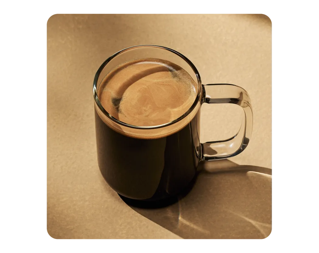 A black americano in a glass mug