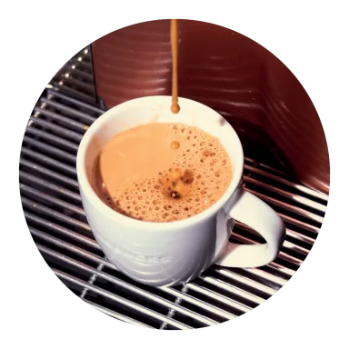 A photo of our classic espresso pouring into a small ceramic cup