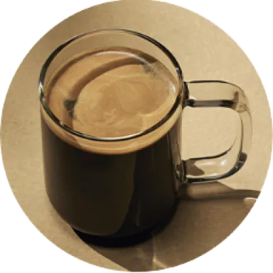 A photo of a black americano in a glass mug.