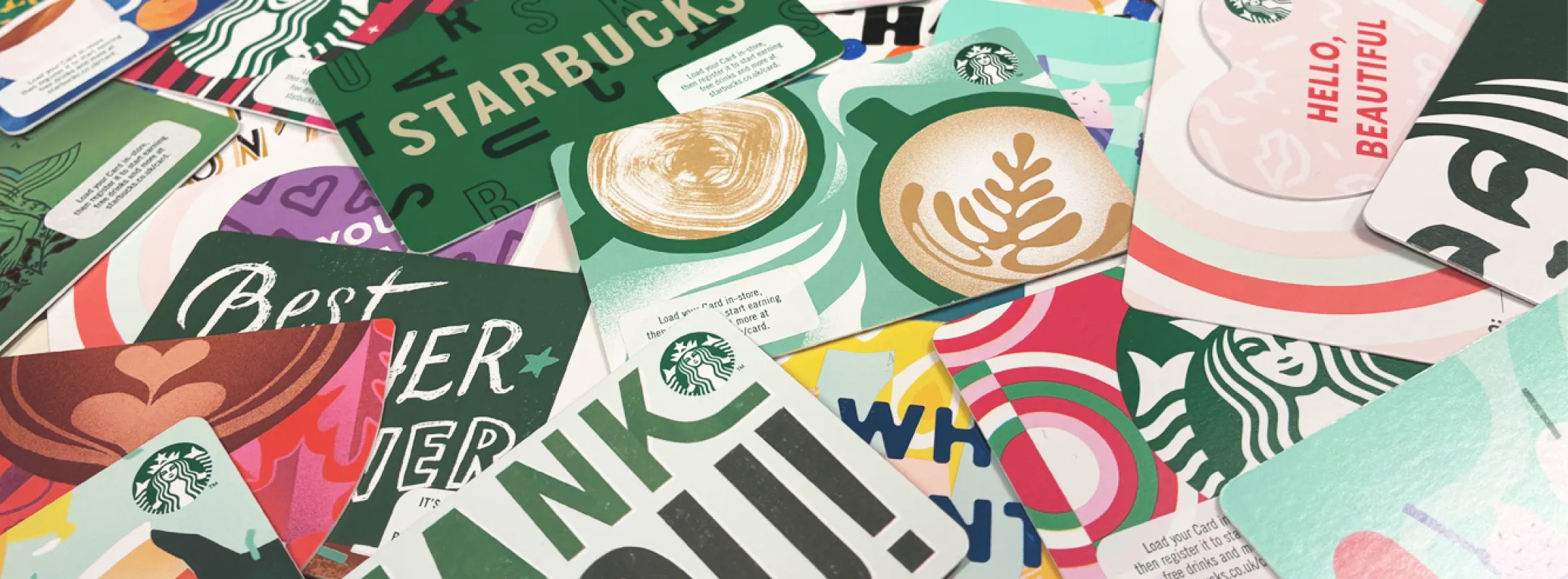 A photo of a selection of colourful Starbucks gift cards scattered