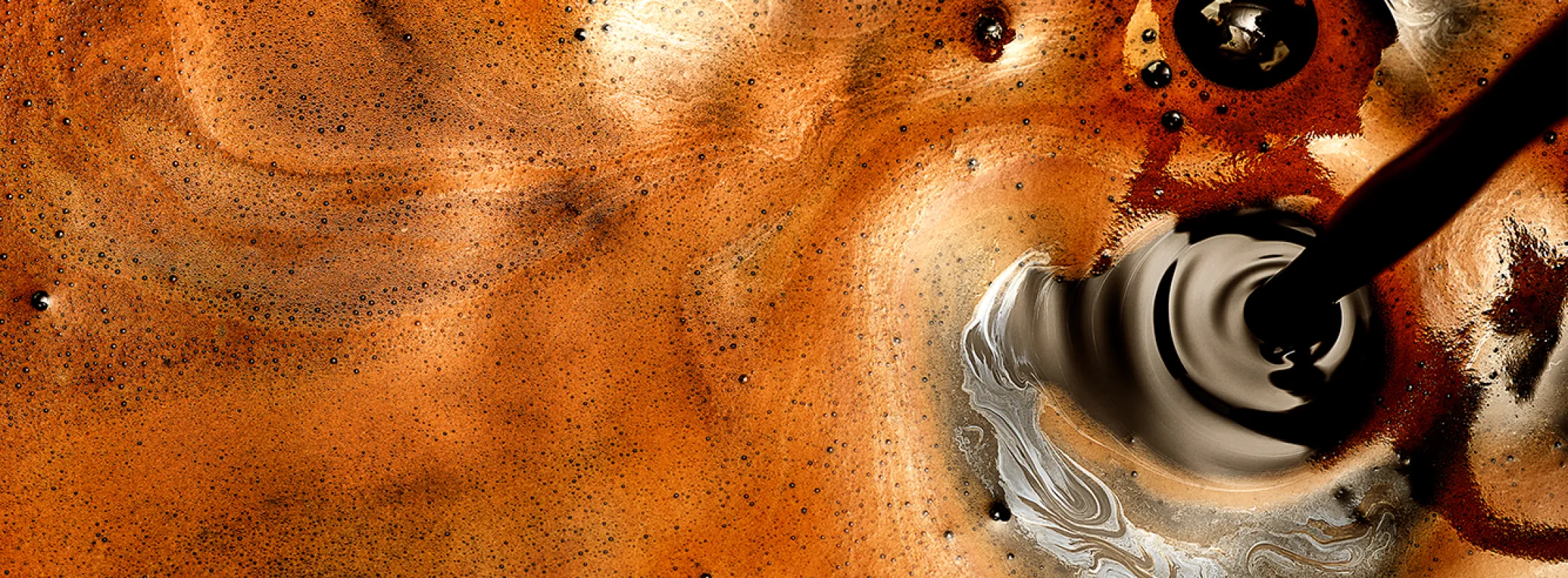 A close up image of a shot of espresso mid-pour