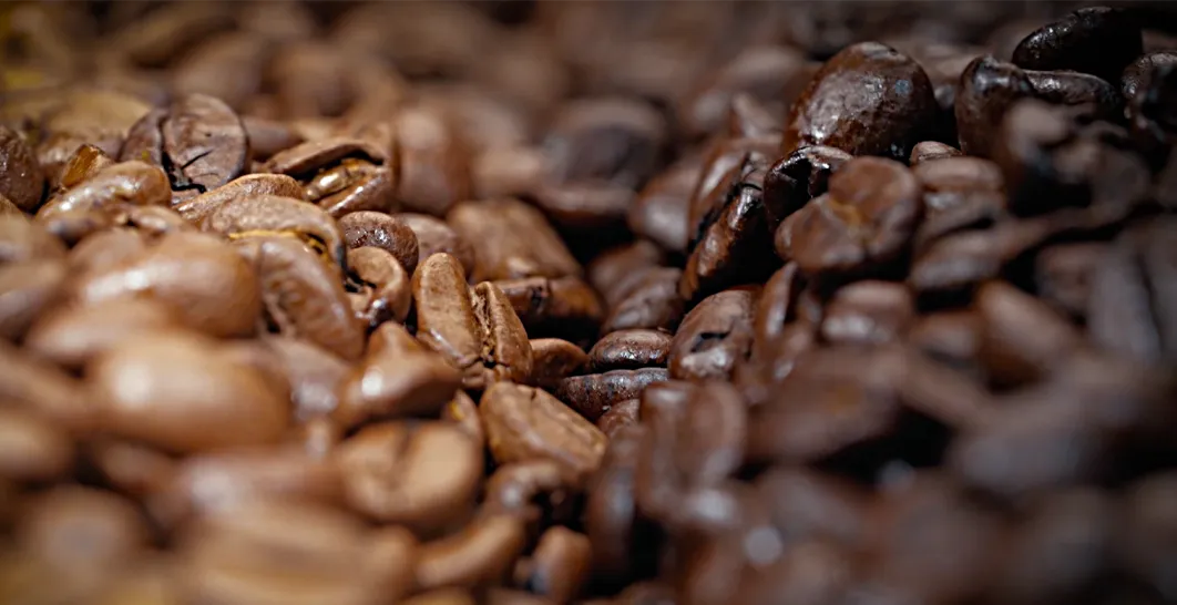 A close up photo of our blonde and dark roasted whole coffee beans