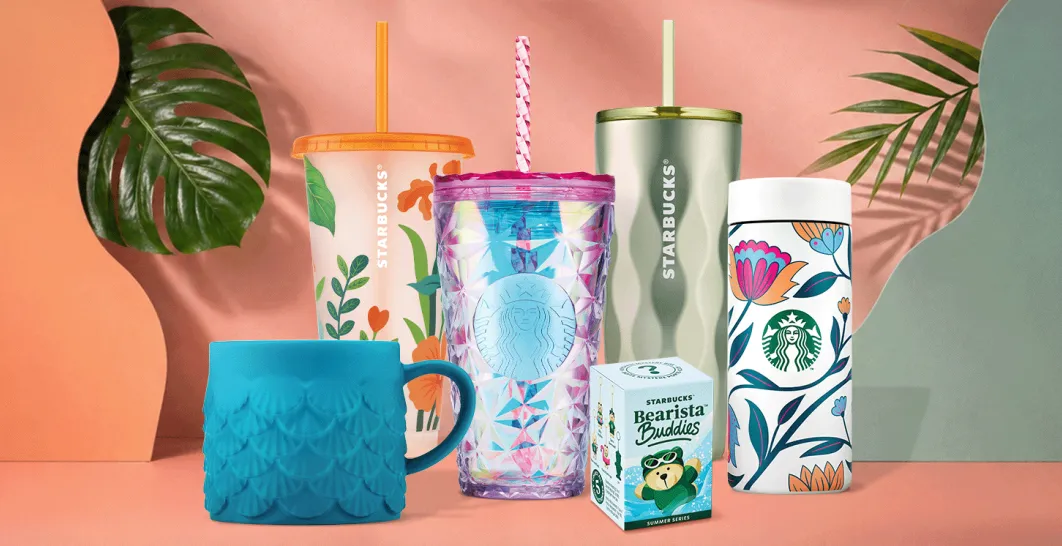 A photo of some selected items from our new merchandise range for summer on a tropical peach background with foliage framing.