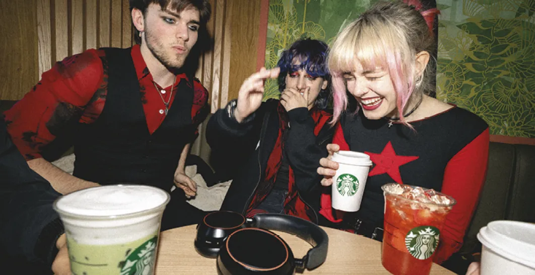 Three friends laughing at a Starbucks Coffeehouse