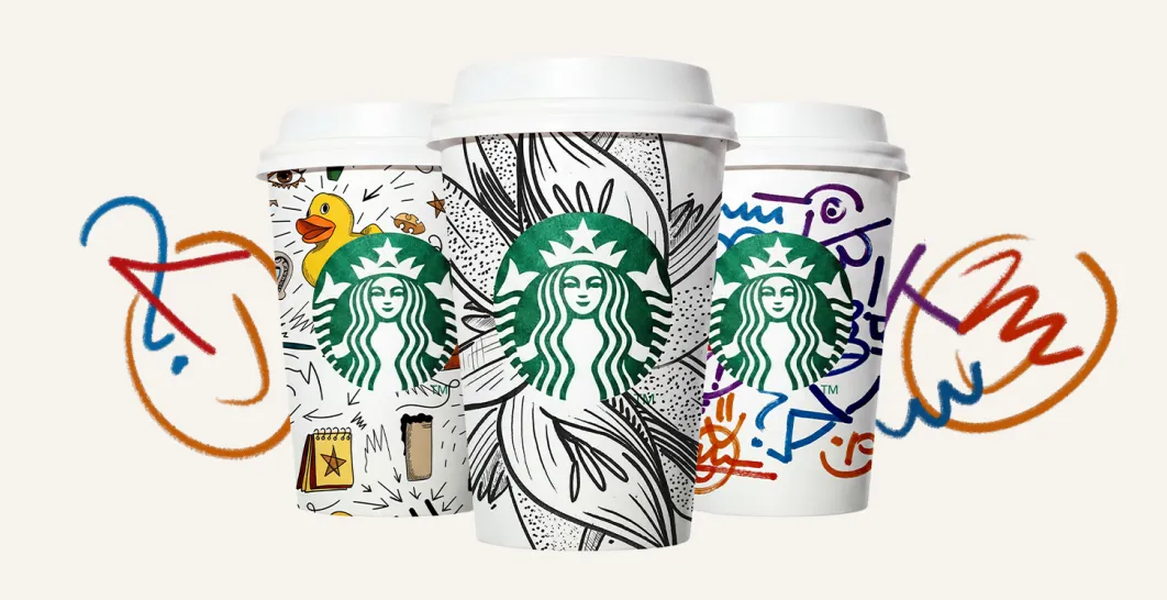 3 Iconic white Starbucks cups completely covered with doodles and illustrations