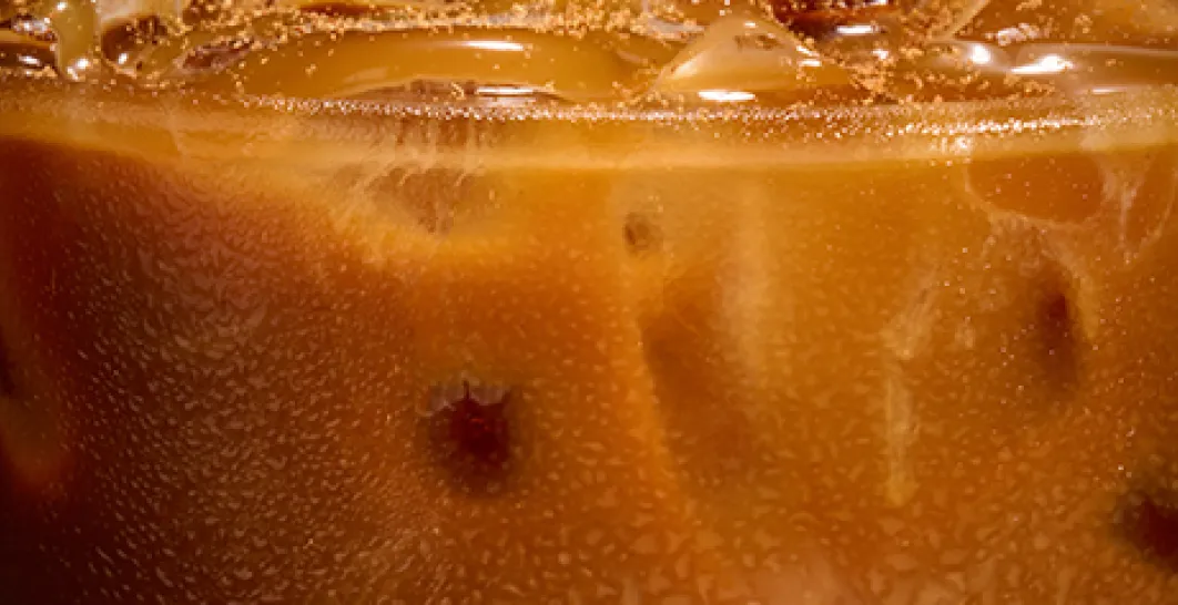 A close up photo of the top of an iced pumpkin spice latte